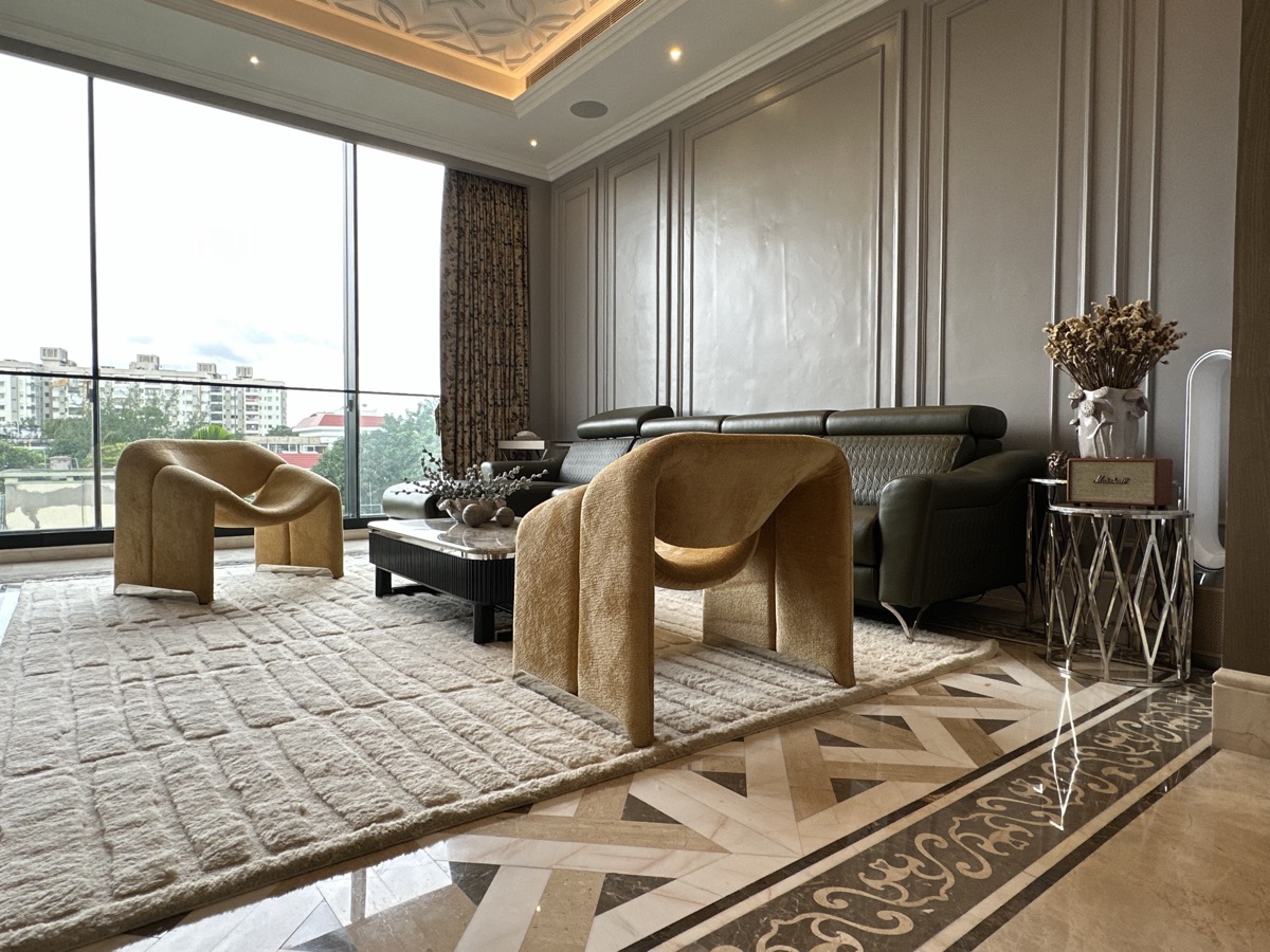 Custom living room with curved seating and an upholstered console