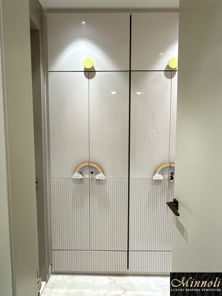 Full-height custom wardrobe with fluted doors and brass handles