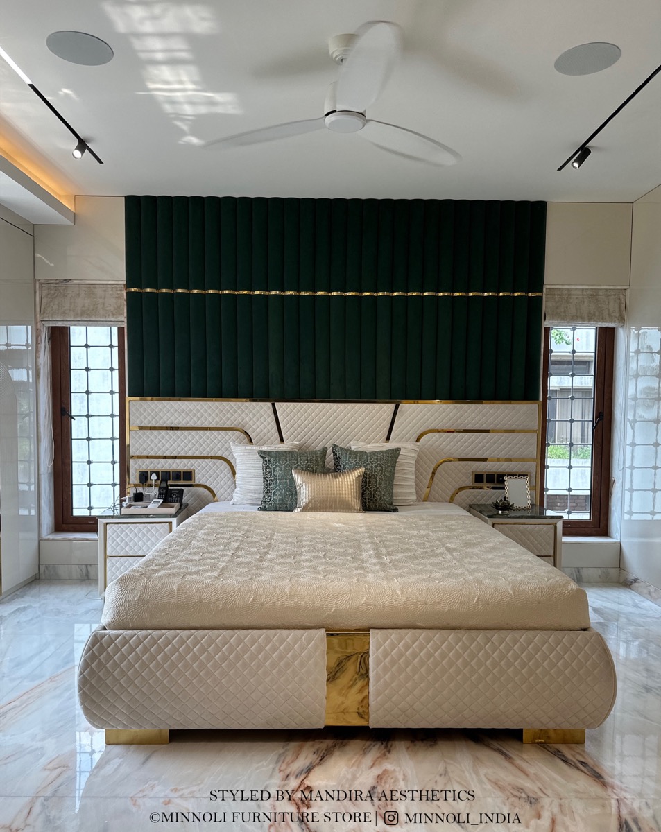 Bespoke upholstered bed with a deep green panelled headboard