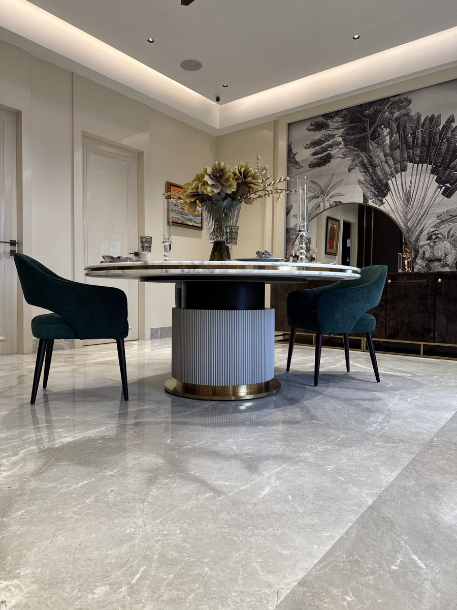 Round custom dining table with upholstered dining chairs