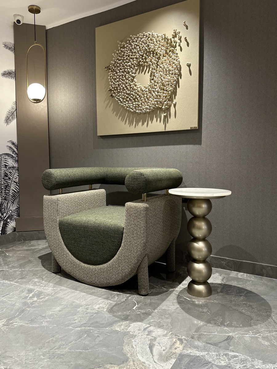 Curved lounge chair and sculptural side table