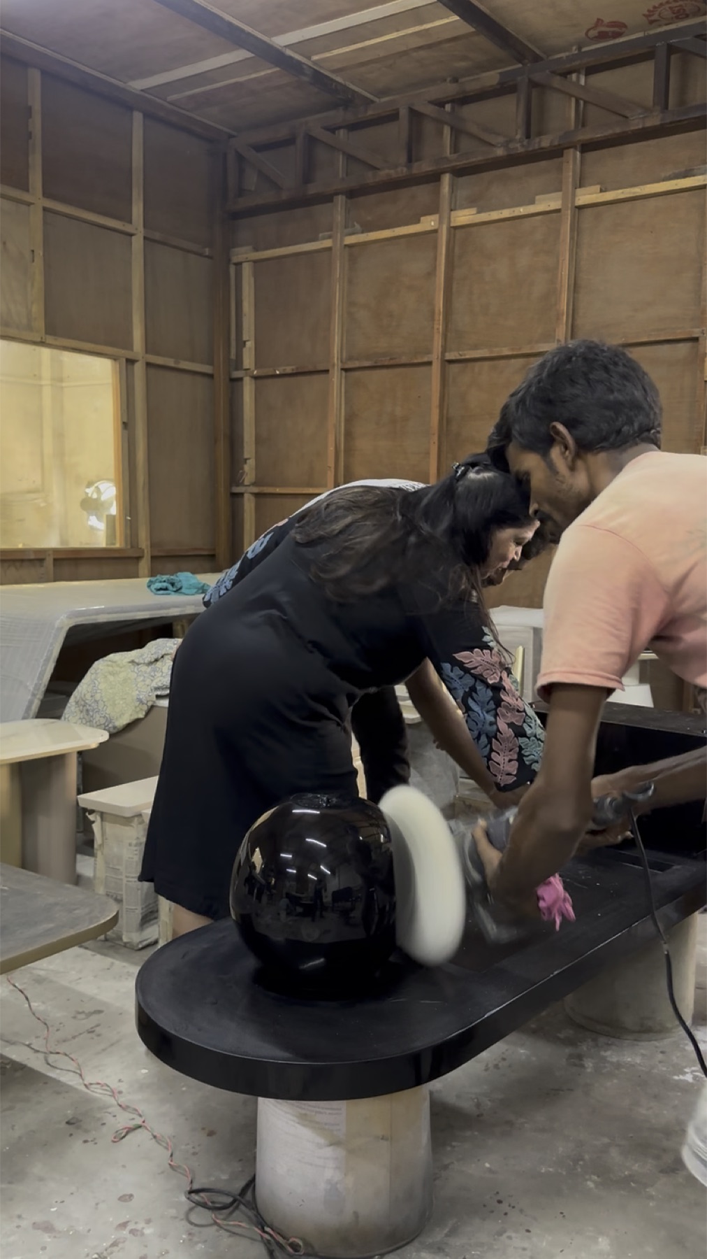 Meenu Narula inspecting furniture with a craftsman in the Minnoli workshop
